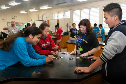 Picture of students interacting with Robotic insect critters.