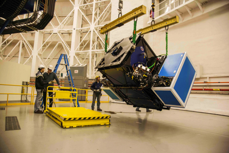 Picture of the GPI inside the dome of Gemini South telescope as it is lifted by a crane