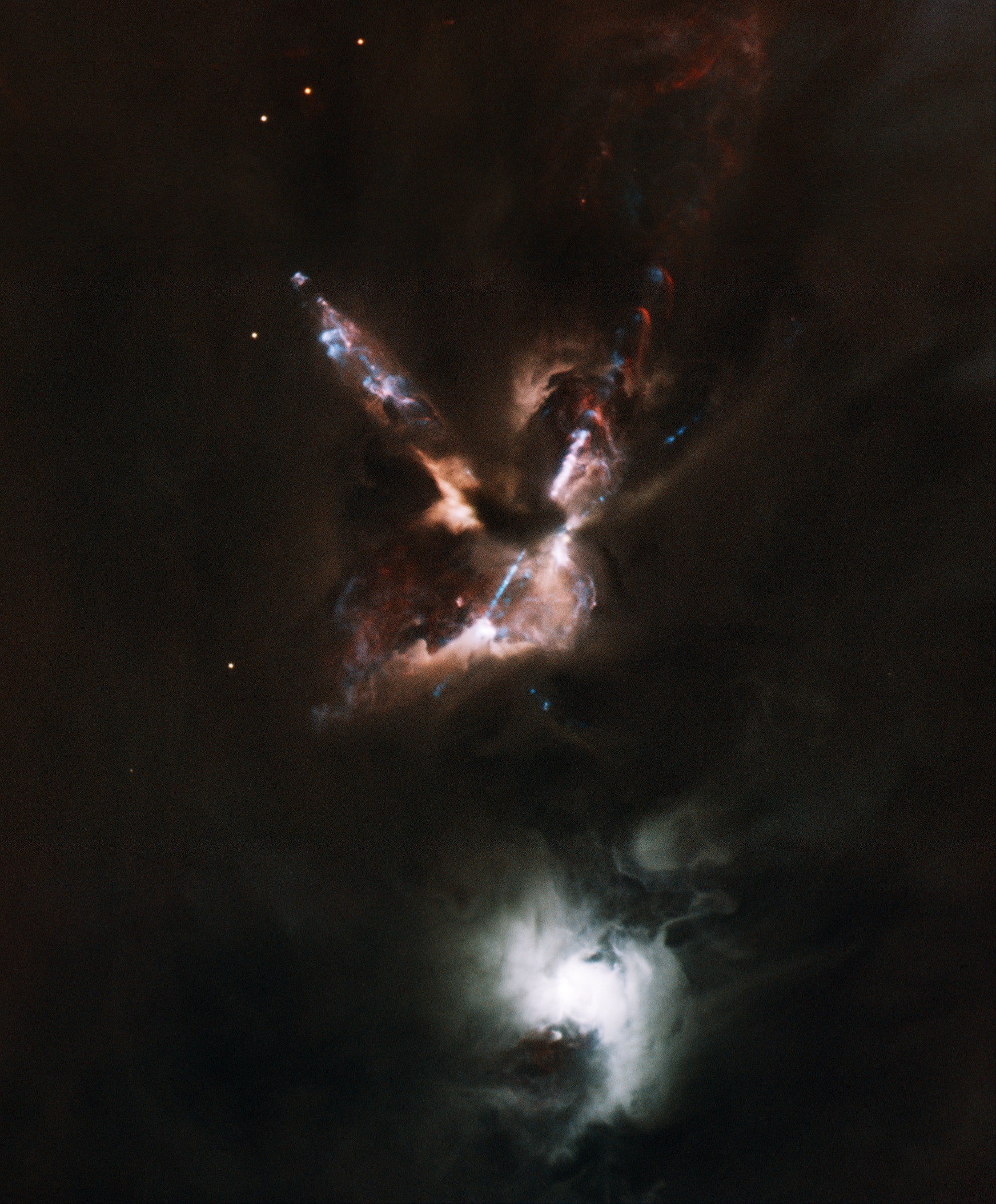 The HH 24 jet complex emanates from a dense cloud core that hosts a small multiple protostellar system known as SSV63. The nebulous star to the south is the visible T Tauri star SSV59. Color image based on the following filters with composite image color assignments in parenthesis: g (blue), r (cyan), I (orange), hydrogen-alpha (red), sulfur II (blue)) images obtained with GMOS on Gemini North in 0.5 arcsecond seeing, and NIRI. Field of view is 4.2x5.1 arcminutes, orientation: north up, east left. Image produced by Travis Rector.