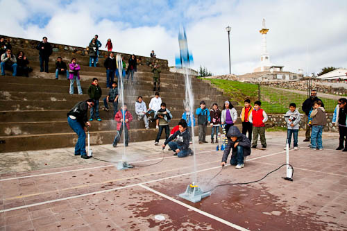 Picture of children launching rockets, which were built by themselves.