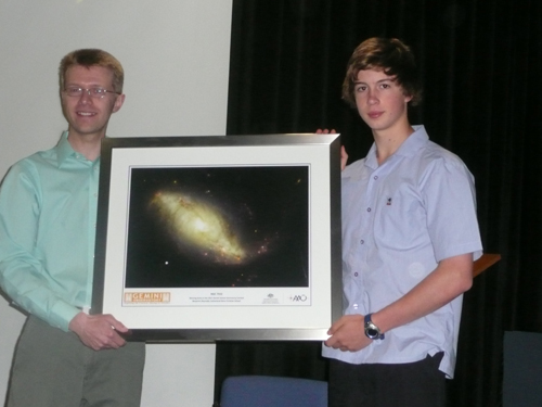 Photo of Benjamin Reynolds (right) receiving a framed copy of his contest-winning image from Christopher Onken (Australian Gemini Office).