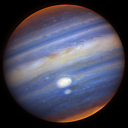 Gemini North near-infrared image of Jupiter. White: high clouds. Blue: lower clouds. Red: deeper clouds. White spots: high-altitude storms. Polar haze brightens north pole.