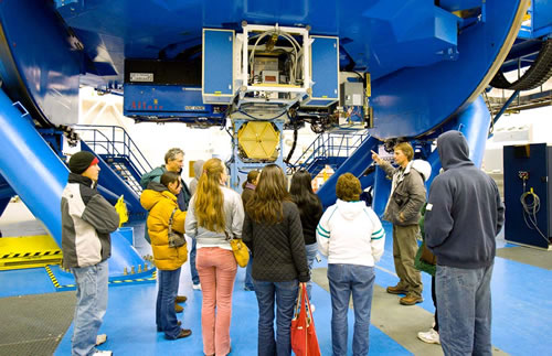 Photo of the Gemini Director Doug Simons explaining the function of the instrument cluster to participants at the Gemini North staff family tour.