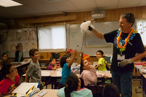 Picture of Gemini PIO Manager Peter Michaud explains condensation, clouds, and sublimation to a group of children.