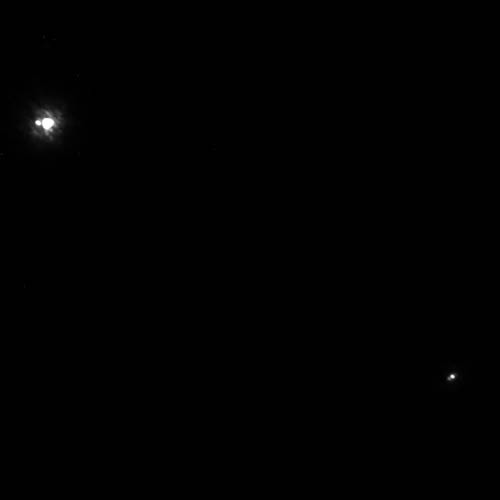 This image shows two binary star systems. The top one has two stars. The bottom one has a brown dwarf and a possible companion (circled).