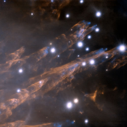 Image shows the Orion "bullets" as blue features and represents the light emitted by hot iron (Fe) gas.