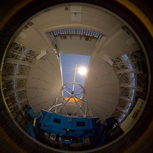 Picture of the moonlight shining through the observing lit as the Gemini laser guide star propagates from the telescope.