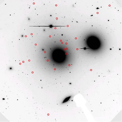 This deep image shows the central region of the Hydra Cluster. Galaxies include a giant elliptical (NGC 3331) in the center, another large elliptical (NGC 3309) above and right, and several faint, possible dwarf galaxy candidates (circled).