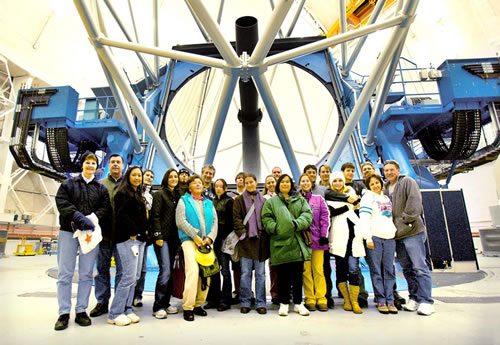 Picture of Gemini North staff family tour participants on December 15th attempting to recreate the photo taken at Gemini South a week earlier!