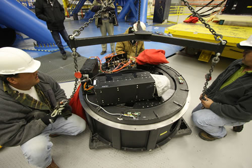 Picture of Chris Yamasaki, Cooper Nakayama, and John White inspecting the PWFS1 module of the acquisition and guiding system.